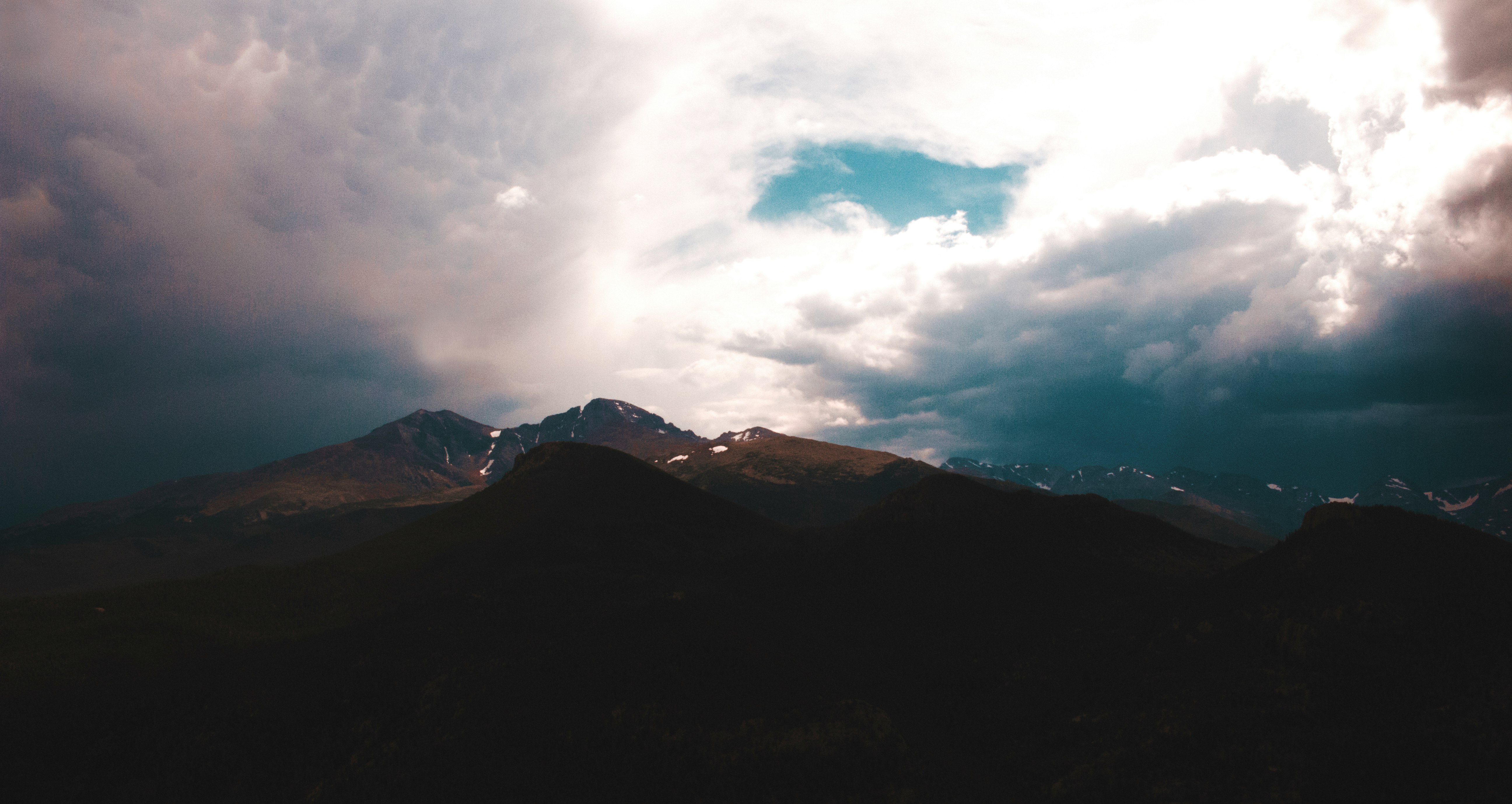 brown mountains under white clouds during daytime